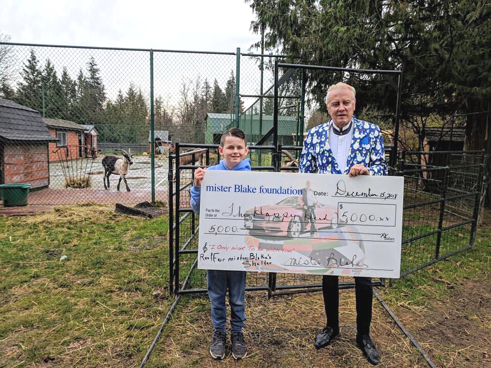 mr. Blake and Matthew with a donation for $5,000